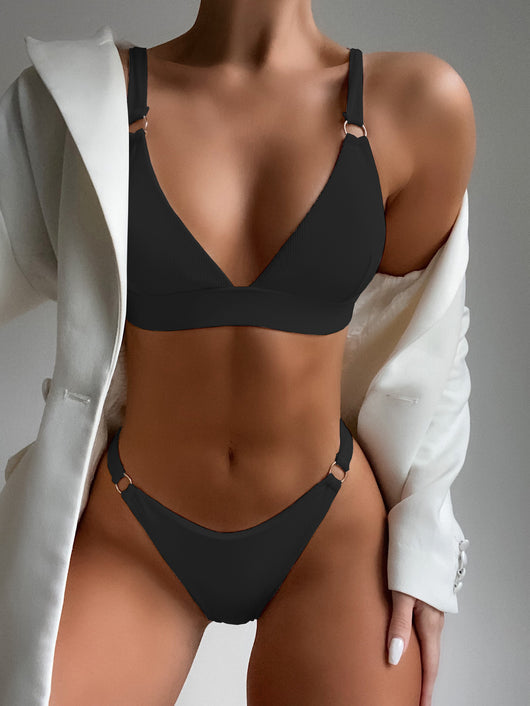 Coral ribbed two-piece bikini with triangle top and O-ring detail on straps and sides, worn by a woman. - Image 2