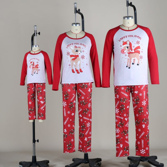 Family of five and a dog wearing matching red and white Christmas pajamas with reindeer and snowflake prints. - Image 2