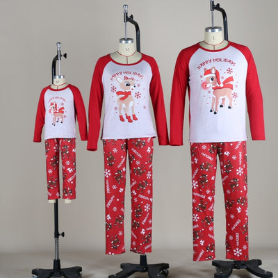 Family of five and a dog wearing matching red and white Christmas pajamas with reindeer and snowflake prints. - Image 2