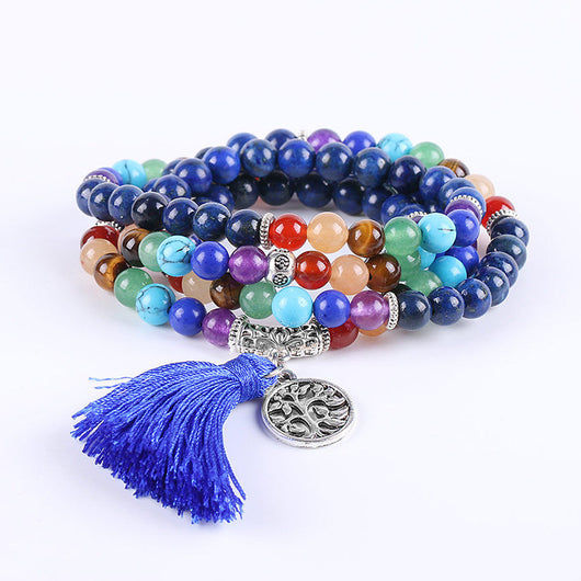 Blue mala prayer beads with chakra colored gemstones, a silver Tree of Life charm, and a blue tassel. - Image 5