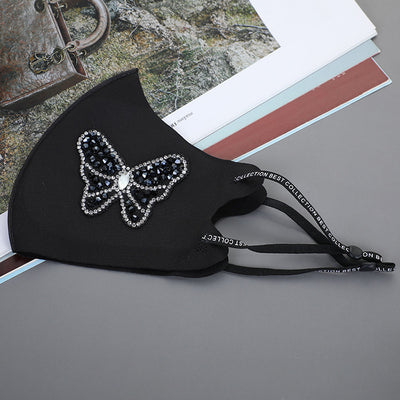 Black ear-mounted mask with a sparkling rhinestone bow pattern, featuring adjustable ear loops. - Image 9