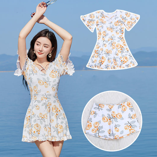 Women's white high-waisted swimsuit with yellow floral print, V-neck, ruffled short sleeves, and ruffled hem. - Image 13