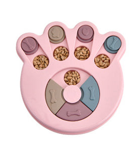 Paw-shaped dog puzzle feeder toy in light yellow with colorful sliding covers, filled with kibble. - Image 16