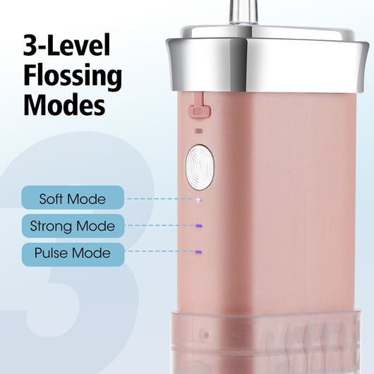 Portable water flosser in gradient pink and blue with four nozzles, a charging cable, and its product box. - Image 33