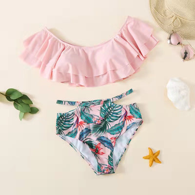 Family matching swimsuits with pink tropical floral and leaf print. Includes women's ruffled bikini, girl's one-piece, and men's/boy's swim shorts. - Image 11