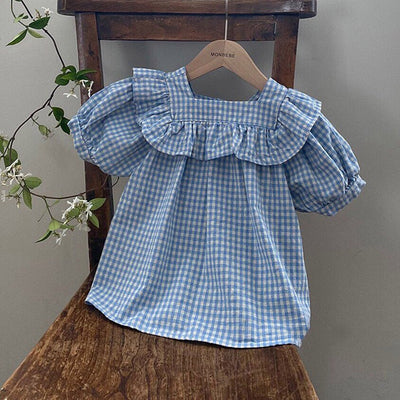 Light blue and white gingham baby romper with puff sleeves and ruffled square neckline, hanging on a wooden chair. - Image 4