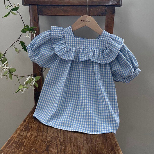 Light blue and white gingham baby romper with puff sleeves and ruffled square neckline, hanging on a wooden chair. - Image 4