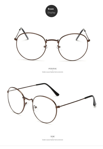 Retro oval anti-blue light glasses with a dark metal frame and clear lenses on a white background. - Image 14