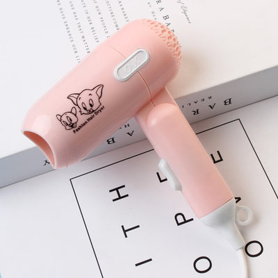 Light blue foldable hair dryer with a cartoon pig design, white power switch, and hanging loop. - Image 8