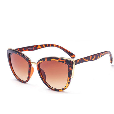 Black cat-eye sunglasses for women with gradient grey lenses and subtle gold-tone metal accents on the frame. - Image 8