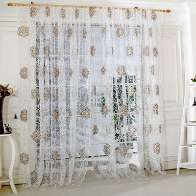 Sheer white European-style floral curtain with brown and gold patterns, hung on a gold rod in a bedroom. - Image 14