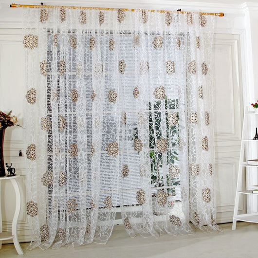 Sheer white European-style floral curtain with brown and gold patterns, hung on a gold rod in a bedroom. - Image 14