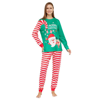 Family of four wearing matching green Christmas pajamas with Santa, reindeer, and red and white striped pants. - Image 13
