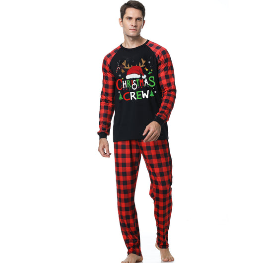 Man wearing a Christmas pajama set with a black long-sleeve top and red and black buffalo plaid pants. - Image 2