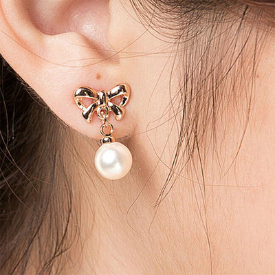 Aretes Elegantes de Corazón con Moño de Circonia y Perla - Image 7