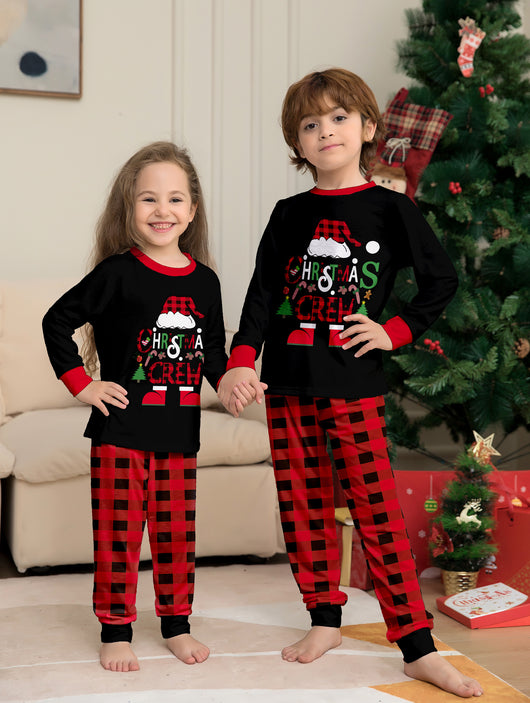 Man wearing black and red plaid Christmas pajamas with a Santa graphic top and matching pants. - Image 3