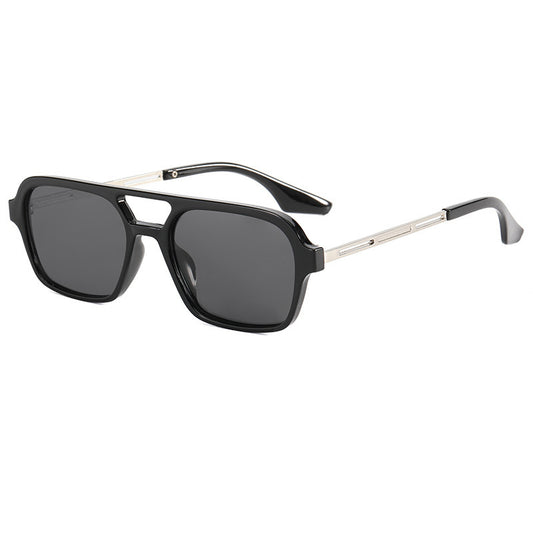 Retro black frame sunglasses with pink square lenses and a double bridge, featuring silver-colored temple accents.