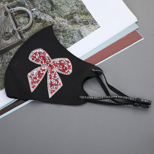 Black ear-mounted mask with a sparkling rhinestone bow pattern, featuring adjustable ear loops. - Image 14