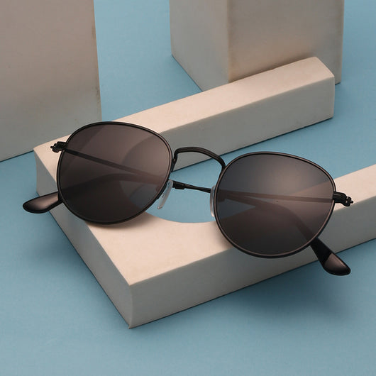 Black metal round frame anti-blue ray glasses with clear lenses, shown at an angle on a white background.