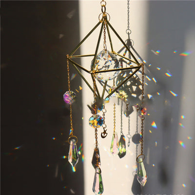 Geometric iridescent suncatcher with a gold frame and dangling crystal pendants, held in a hand, creating rainbow light. - Image 14