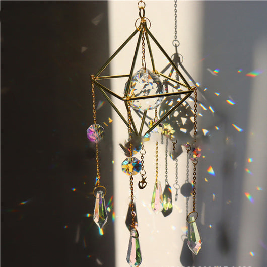 Geometric iridescent suncatcher with a gold frame and dangling crystal pendants, held in a hand, creating rainbow light. - Image 14