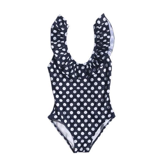Mother and three children in matching black and white polka dot one-piece swimsuits with ruffled straps. - Image 4