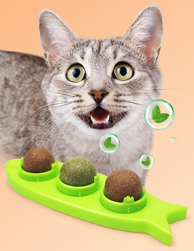 Pink fish-shaped cat molar stick toy with three compartments holding green and brown catnip or silvervine balls. Three clear plastic dome covers are shown. - Image 8