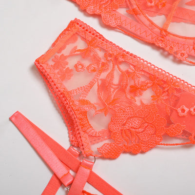 Purple embroidered lace three-piece lingerie set with underwire bra, thong, and garter belt on a white surface. - Image 18