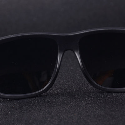 Men's grey plastic frame driving sunglasses with dark polarized lenses and red and black stripe detail on temples. - Image 4