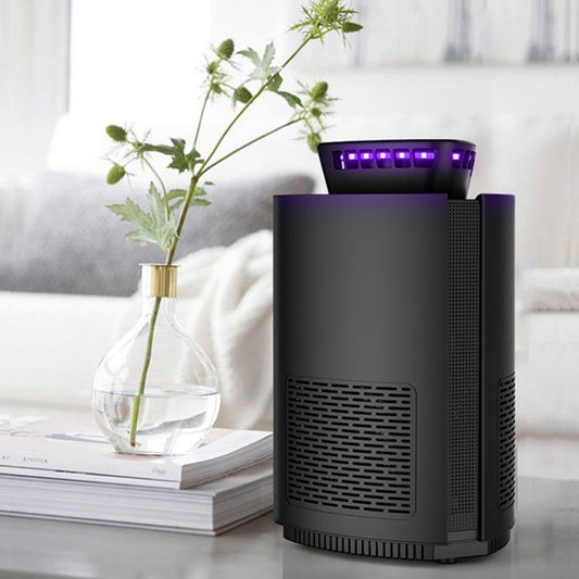 Black intelligent mosquito repellent light with purple glow and four 4.13-inch round sticky traps.