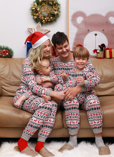 Family of four wearing matching white, red, and green fair isle Christmas pajamas with reindeer and snowflake patterns. - Image 10