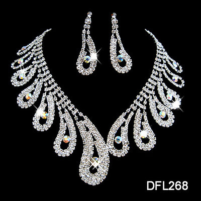 Silver-toned rhinestone necklace and matching drop earrings set with iridescent accents, ideal for bridal or formal wear.