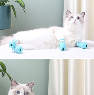 Four teal rubber cat paw covers with white hook-and-loop straps and paw print details, designed for anti-scratch protection. - Image 12