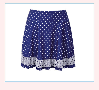 Woman in a cute and sweet three-piece swimsuit with a sheer white polka dot long-sleeve top and navy blue polka dot swim skirt. - Image 14