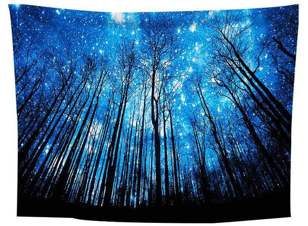 Tapestry featuring a vibrant blue starry night sky seen through a dense forest of tall, dark, bare trees.