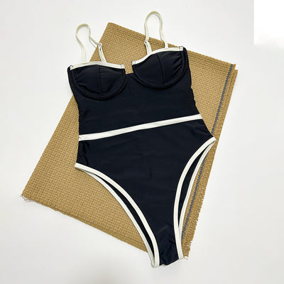 Black one-piece swimsuit with white trim, thin straps, sweetheart neckline, and high-cut leg on a model. - Image 3