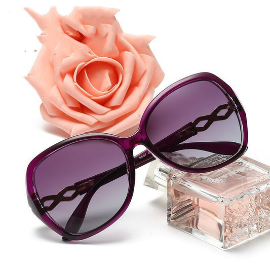 Women's purple oversized polarized sunglasses with gradient lenses and gold chain link detail on the temples. - Image 2