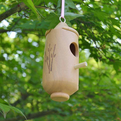 Light brown wooden birdhouse with a conical roof, circular entrance, perch, and etched branch design, hanging hook. - Image 12