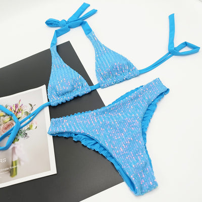 Pink and yellow sequined halter bikini top and high-cut bottoms on a model against a clear blue sky. - Image 5