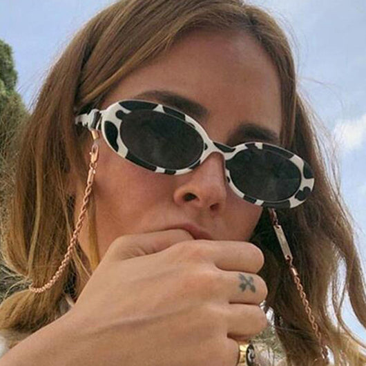 Small frame oval sunglasses with a tortoiseshell pattern and brown lenses on a white background. - Image 2