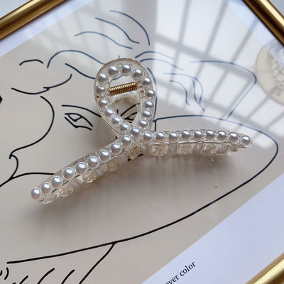 Clear plastic hair claw clip adorned with a single row of white faux pearls and a gold-toned spring. - Image 7