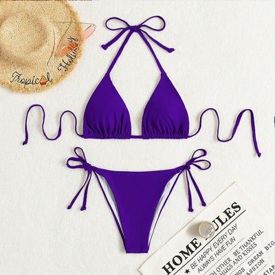 Neon yellow halter bikini with triangle top and tie-side bottoms, displayed on a light wood surface. - Image 23
