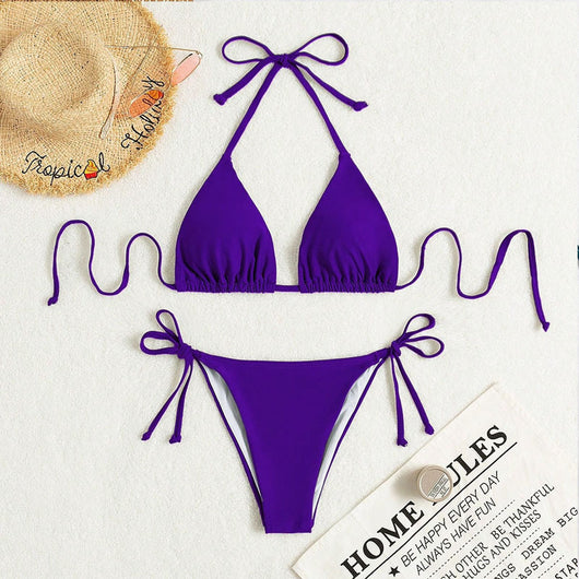 Neon yellow halter bikini with triangle top and tie-side bottoms, displayed on a light wood surface. - Image 23