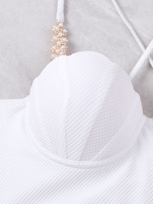 White textured two-piece bikini with a scalloped top and high-waisted bottom, worn by a woman on a sandy beach. - Image 10