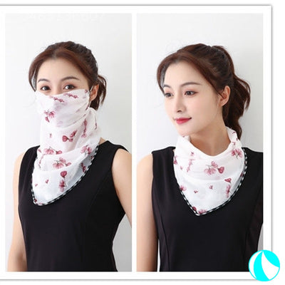 White women's UV protection scarf with black speckle pattern, worn as a face mask and neck scarf. - Image 15