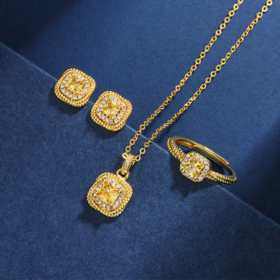Women's gold-toned jewelry set with a ring, necklace, and stud earrings, each featuring a square yellow gemstone surrounded by small clear stones. - Image 2