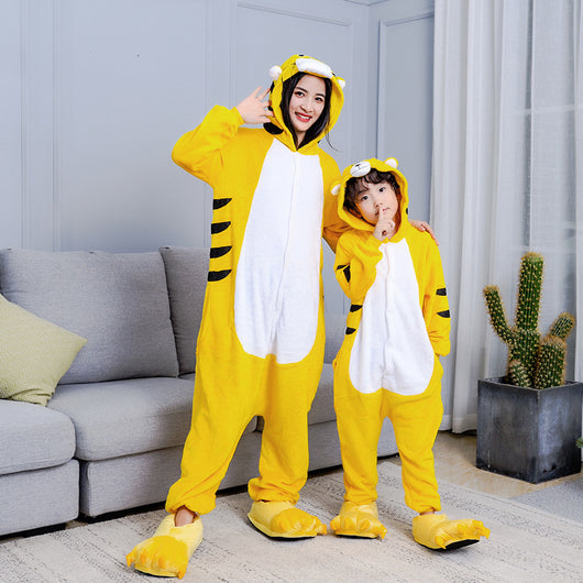 Young child in a yellow tiger hooded flannel pajama jumpsuit with white belly and black stripes, standing indoors. - Image 5