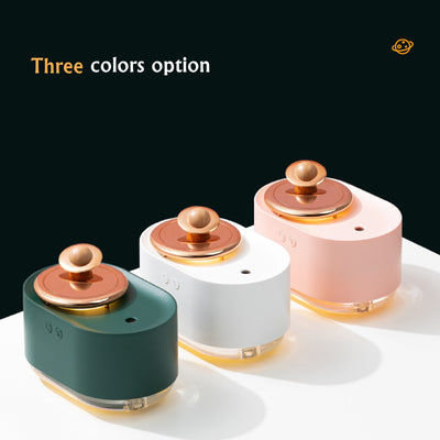White USB rechargeable mini humidifier with a rose gold top accent and a wooden planet decoration. - Image 11