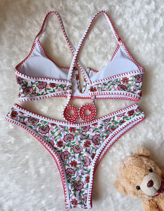 White two-piece swimsuit with red and green floral print, V-neck top, criss-cross straps, and high-cut bottoms. - Image 6