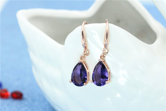 Rose gold necklace with a teardrop purple gemstone pendant and matching dangle earrings. - Image 21